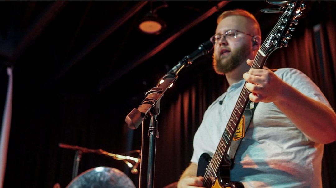 Colton mid-riff on stage